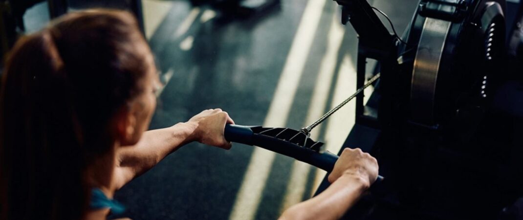 stock-photo-close-up-of-sportswoman-exercising-on-rowing-machine-in-gym-2399913603